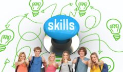 The word skills and smiling group giving a thumbs up as they wear backpacks against blue push button